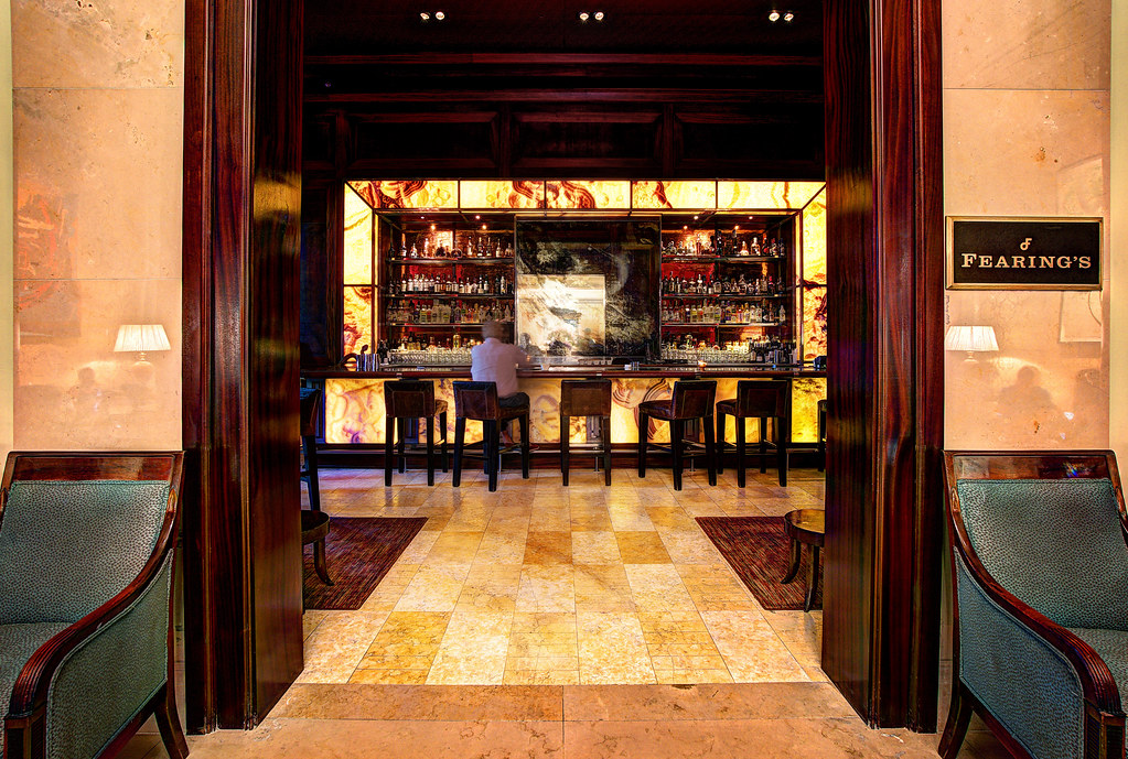 This is image of the inside of the Ritz-Carlton, in Dallas. It is a very high-status building featuring nice chairs. 