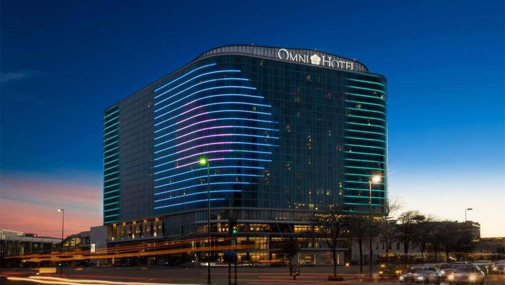 The outside of the Omni Dallas Hotel is visible at a time of day which is probably twilight. 